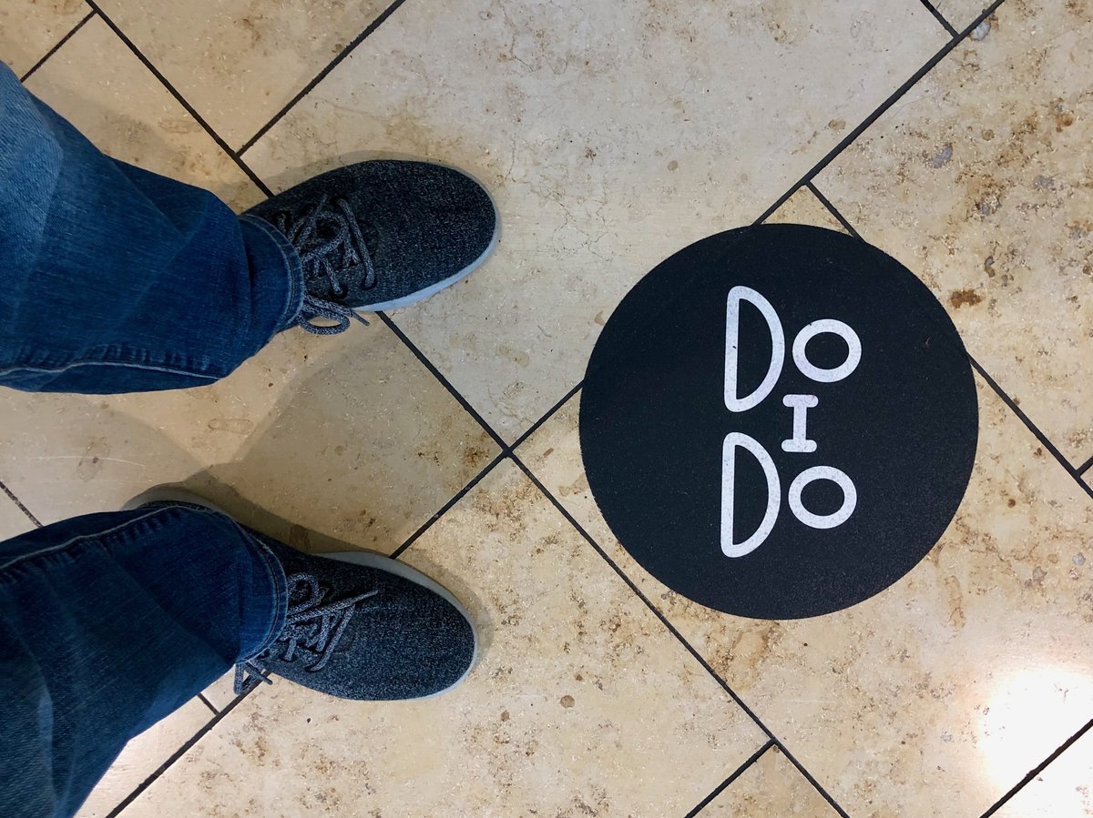 Social distancing reminder stickers on the floor outside the Apple store in Toledo, OH.